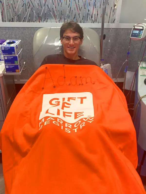 Adam LeBlanc donating stem cells under a Gift of Life blanket