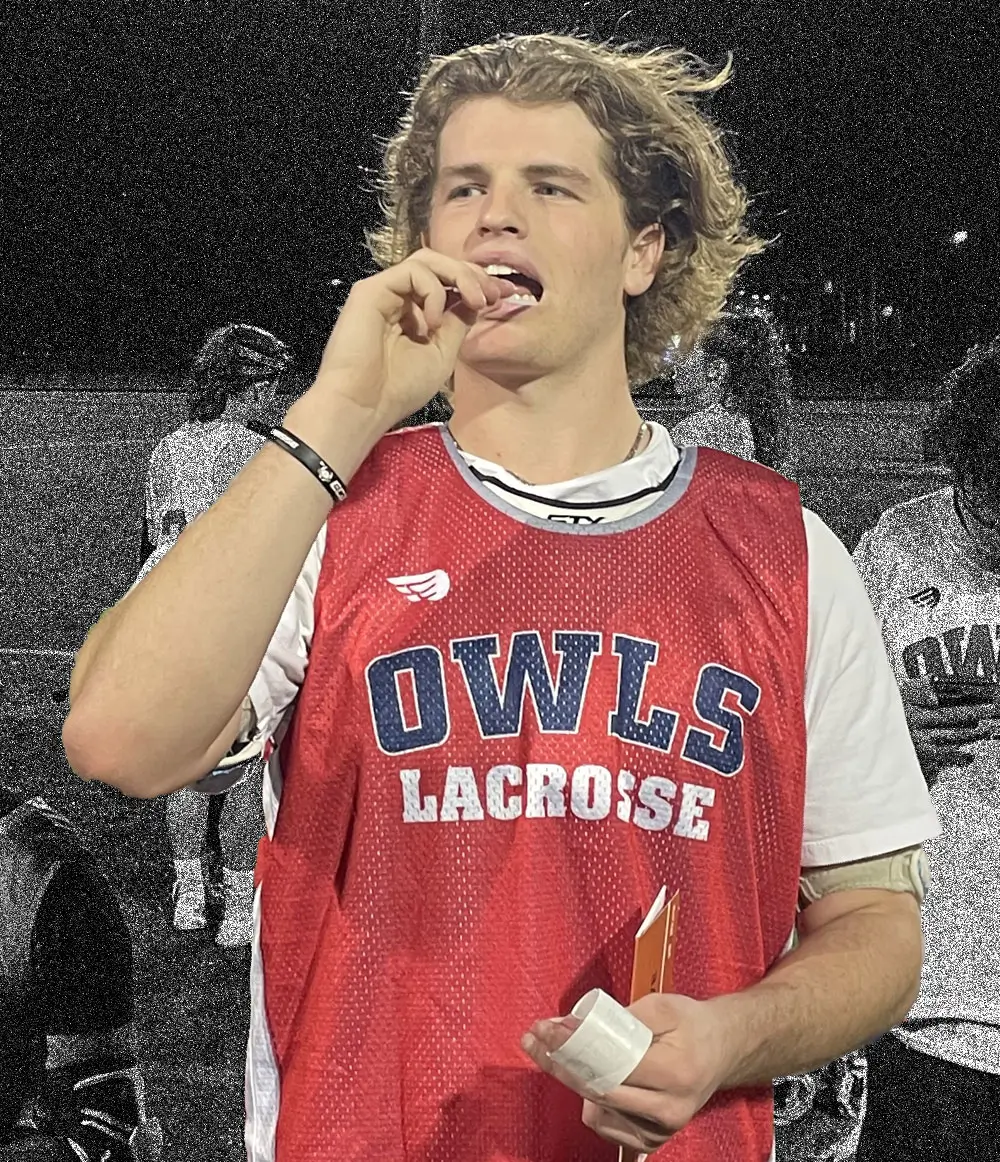 An Owls lacrosse player swabbing his cheek