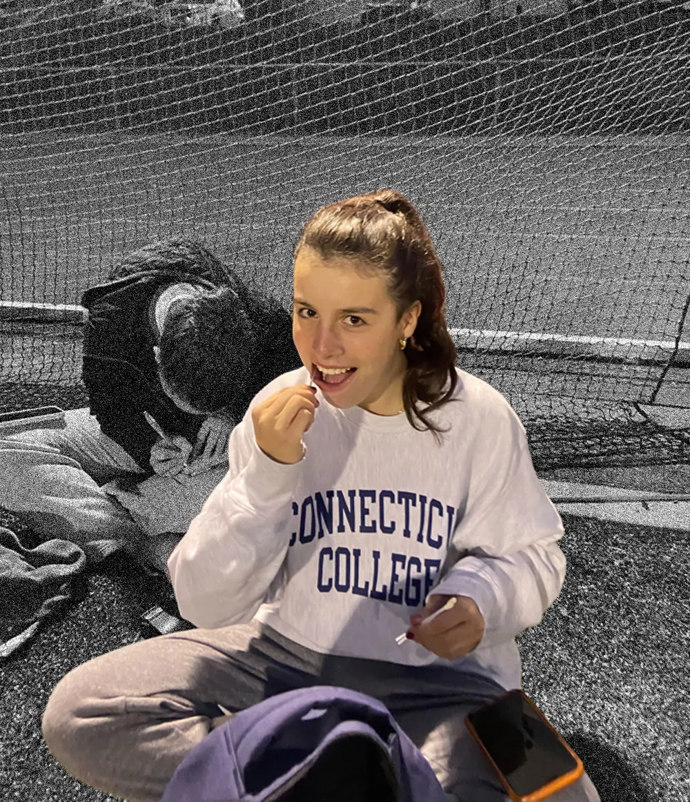 A Connecticut College student-athlete swabbing her cheek
